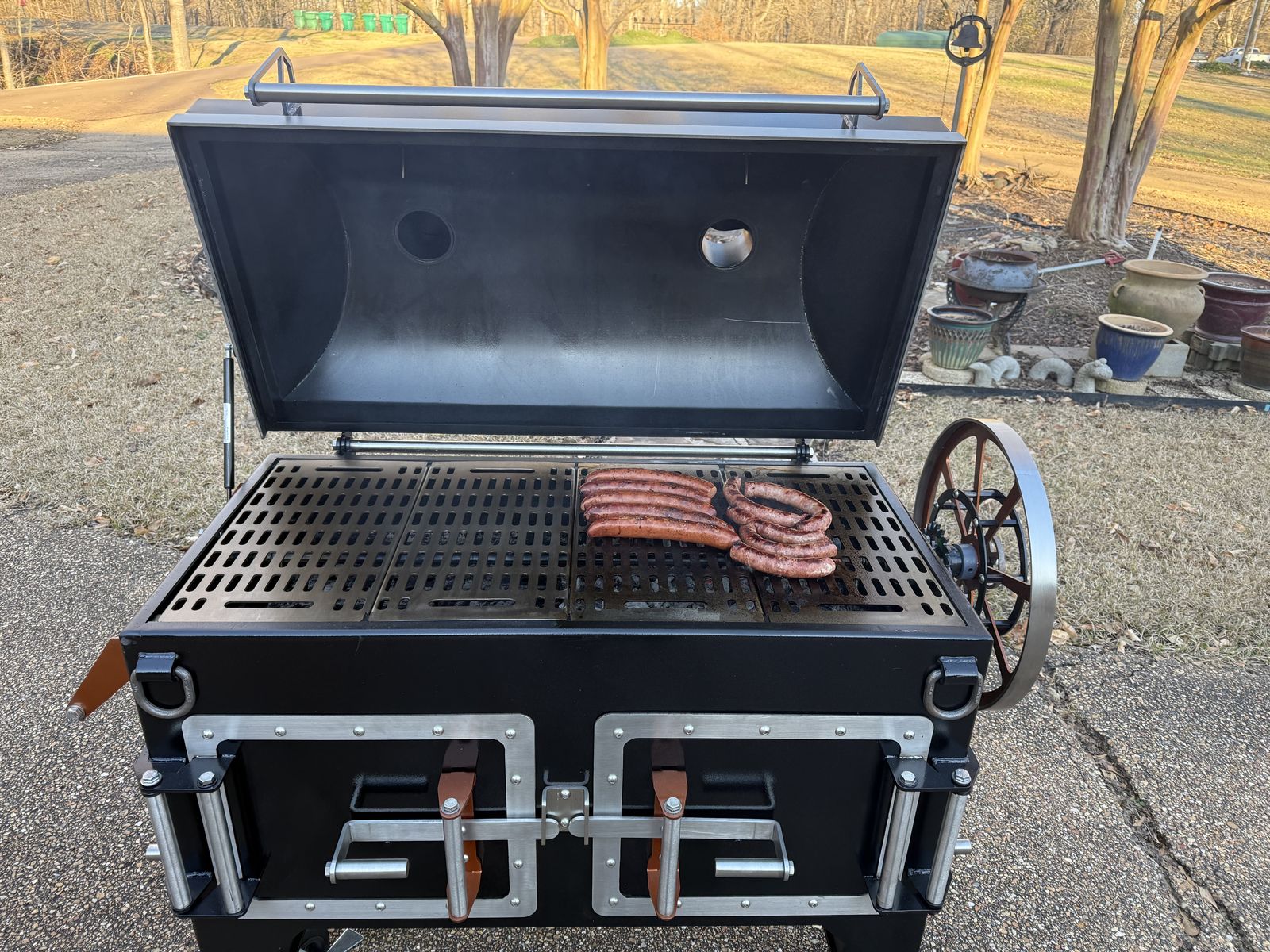 Sausages cooking on a Legacy disc cooker