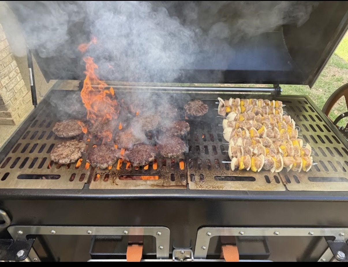 Burgers and kabobs cooking over open flame on a Legacy grill